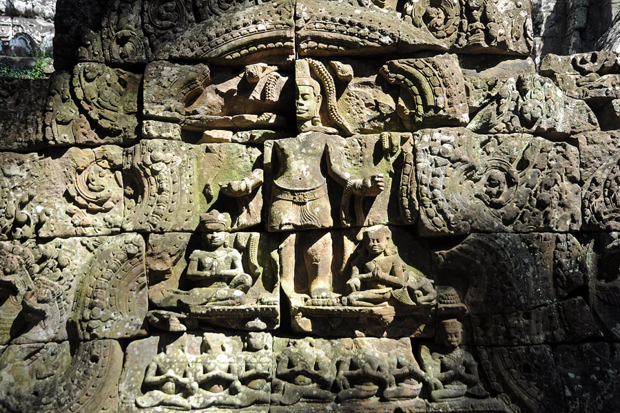 Lokeshvara flanked by two kneeling demons in royal dresses